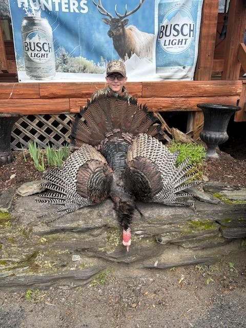 Hunter with a fanned-out turkey