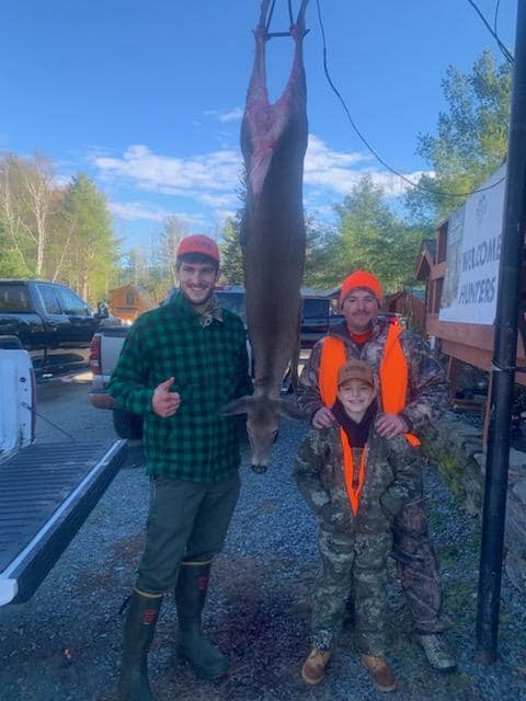 Hunters with a big buck at Swiftwater